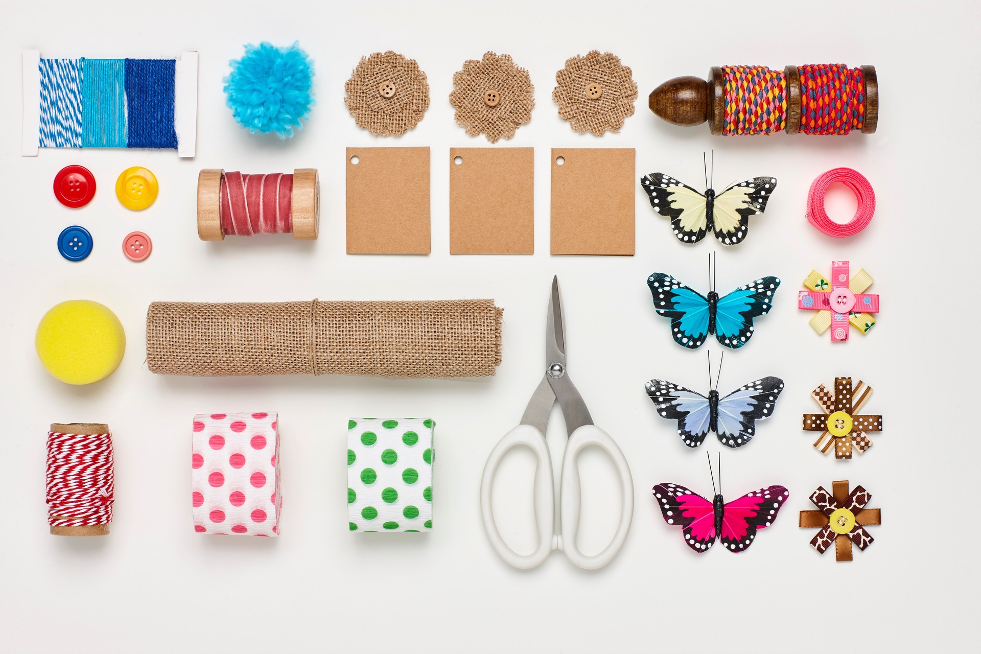 Overhead flat lay of various craft products on white background